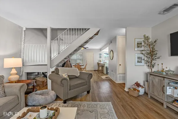 a living room with furniture and wooden floor