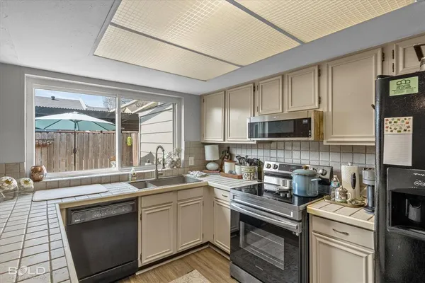 a kitchen with a sink stove and cabinets