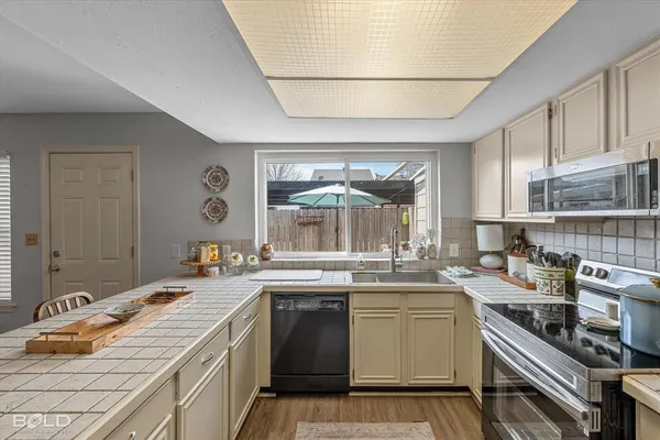 a kitchen with a sink stove and cabinets