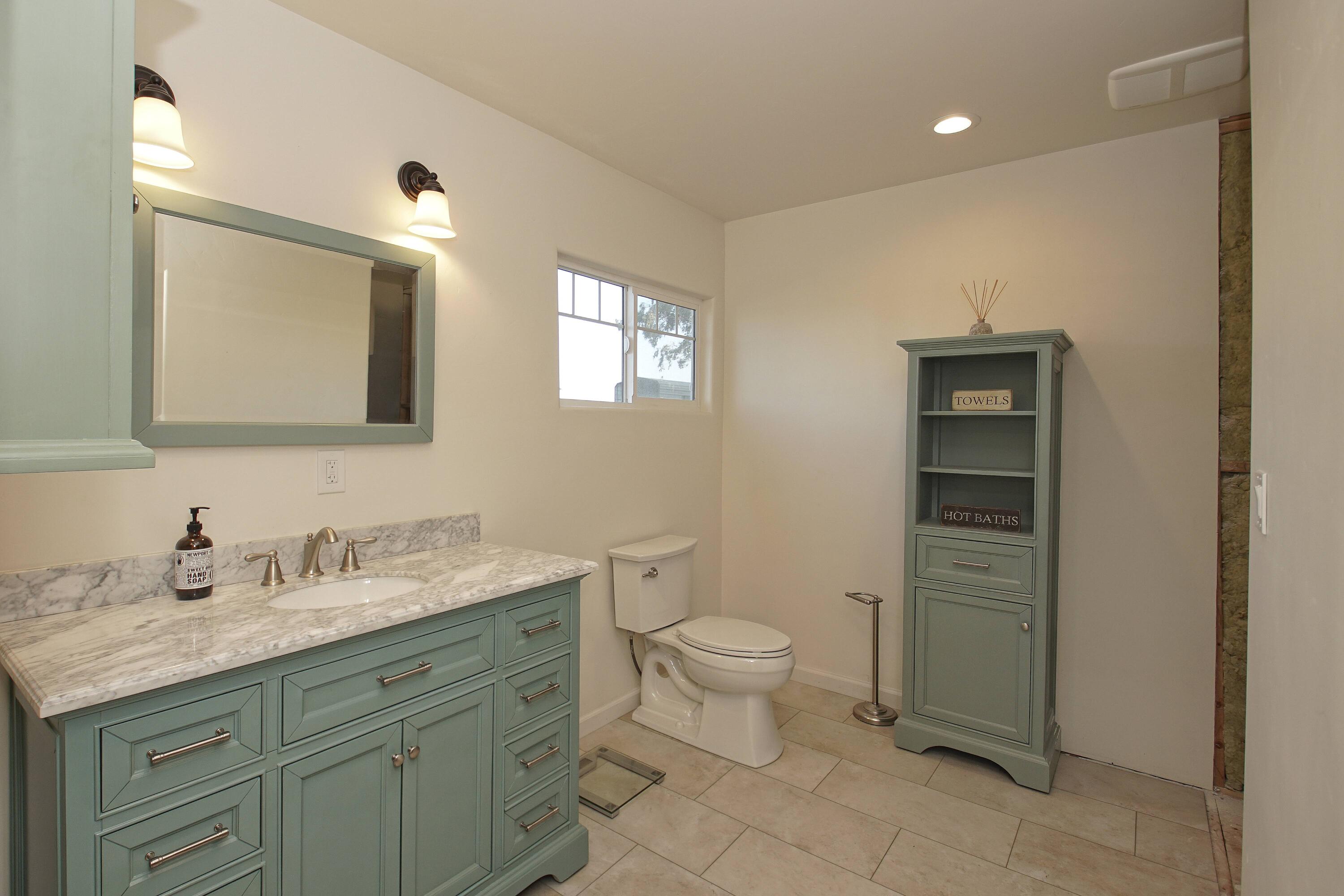 6280 Santa Clara Road Corning, CA 96021 - Photo 38 of 53 a bathroom with a granite countertop toilet sink and mirror