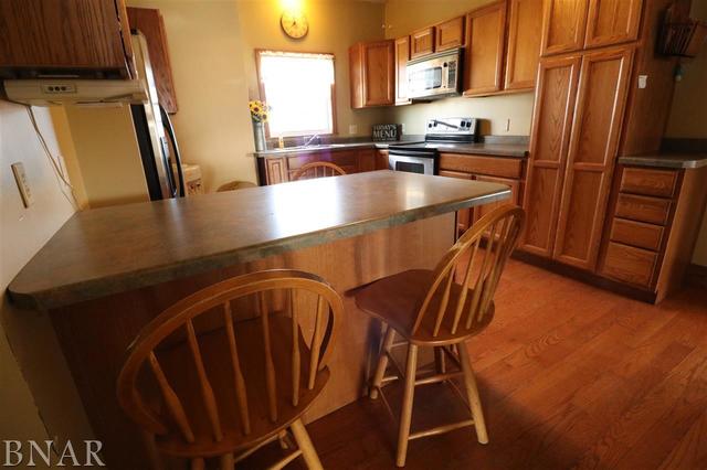 2234 Bearsdale Road Maroa, IL 61756 - Photo 7 of 17 a kitchen with stainless steel appliances a refrigerator a sink a stove and white cabinets