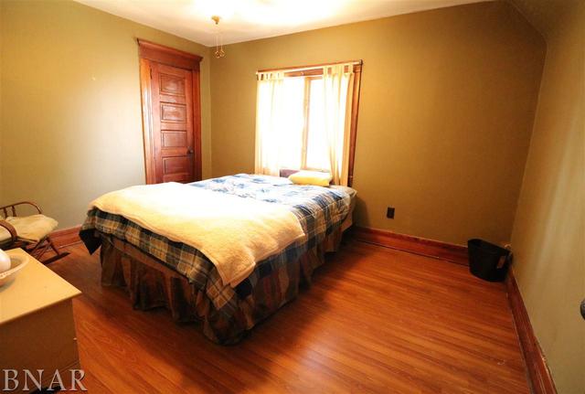 2234 Bearsdale Road Maroa, IL 61756 - Photo 10 of 17 a spacious bedroom with a bed and a dresser