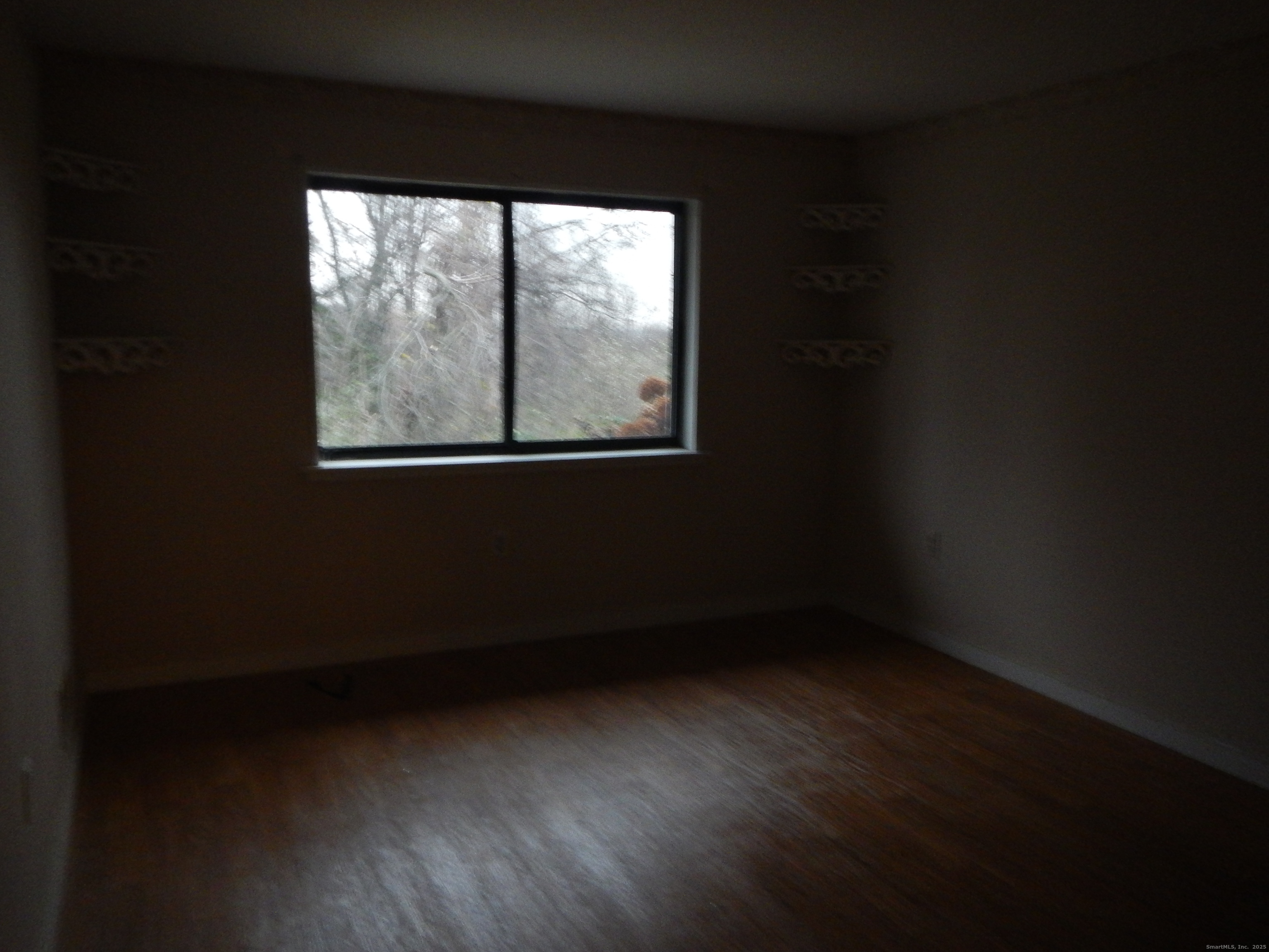 444 Asbury Ridge, Unit 444 Shelton, CT 06484 - Photo 5 of 7 a view of an empty room with a window