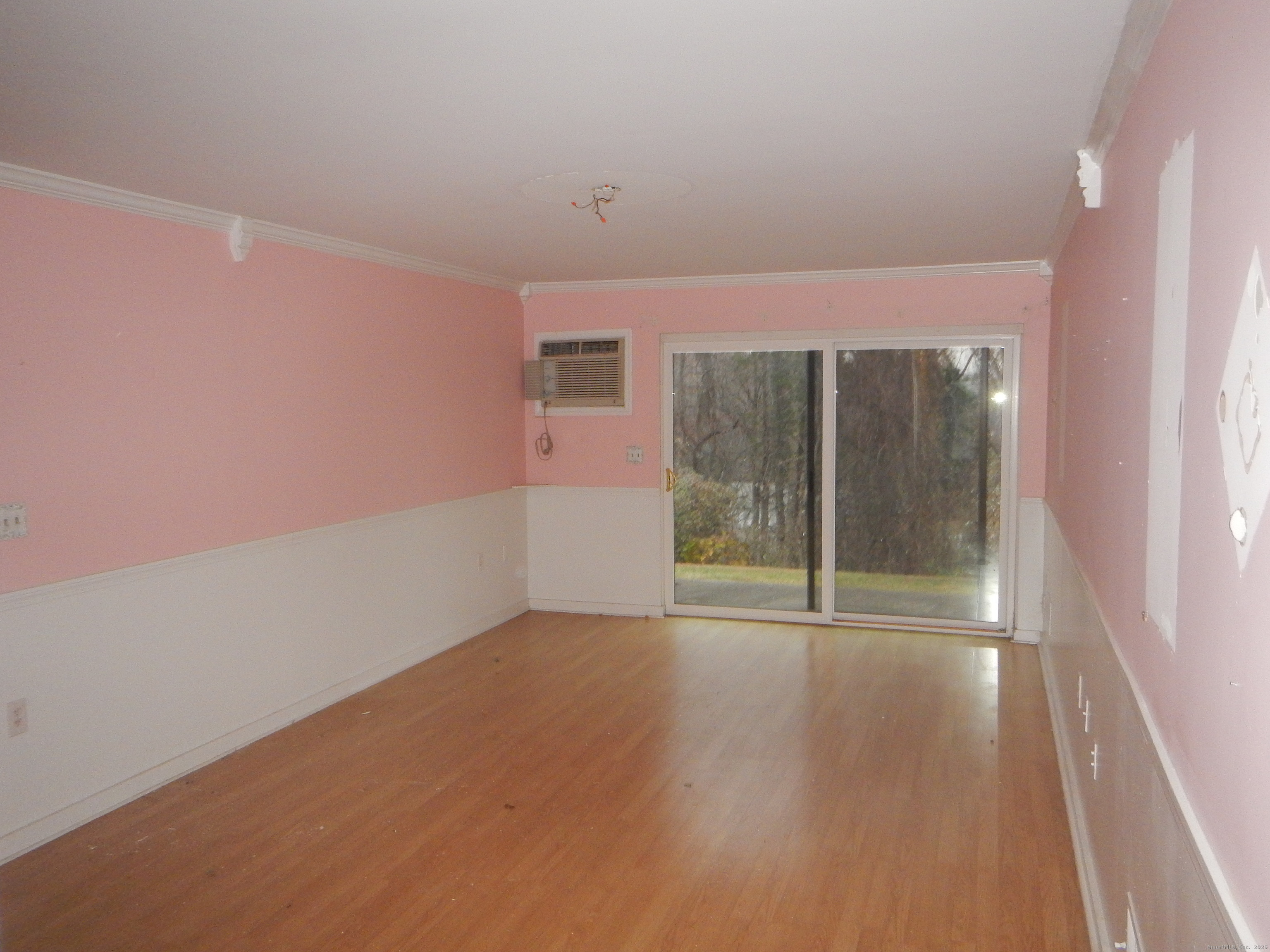 444 Asbury Ridge, Unit 444 Shelton, CT 06484 - Photo 6 of 7 wooden floor in an empty room with a window