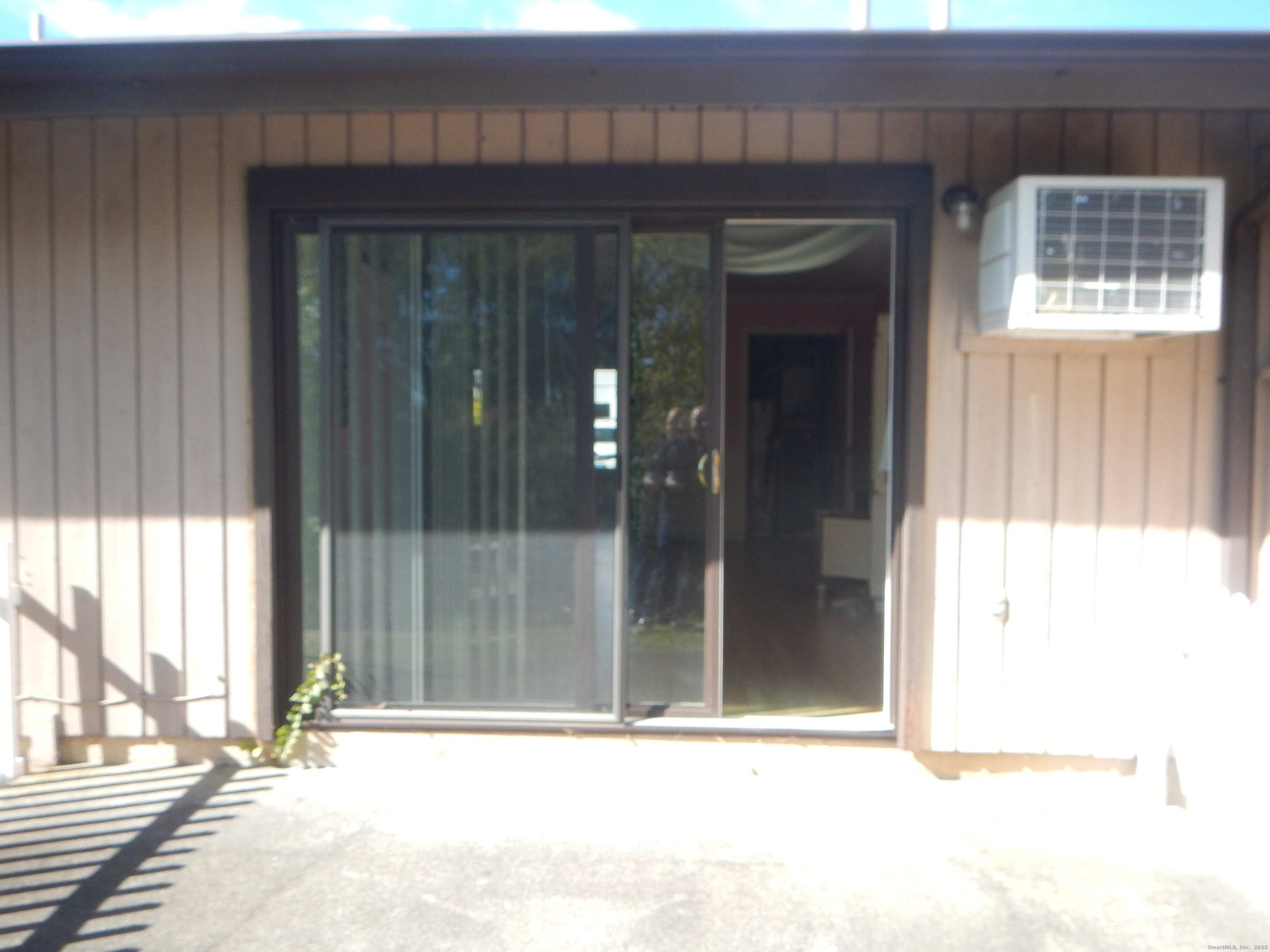 444 Asbury Ridge, Unit 444 Shelton, CT 06484 - Photo 7 of 7 a view of outdoor space with sliding door and wooden floor