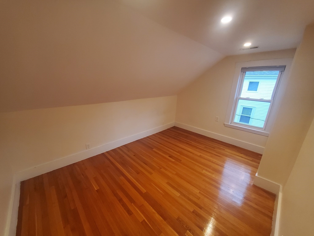 68 Nahant Avenue, Unit 2 Boston, MA 02122 - Photo 12 of 19 an empty room with wooden floor and windows
