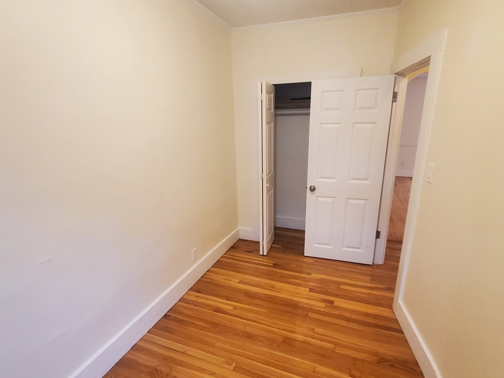68 Nahant Avenue, Unit 2 Boston, MA 02122 - Photo 15 of 19 a view of an empty room with wooden floor