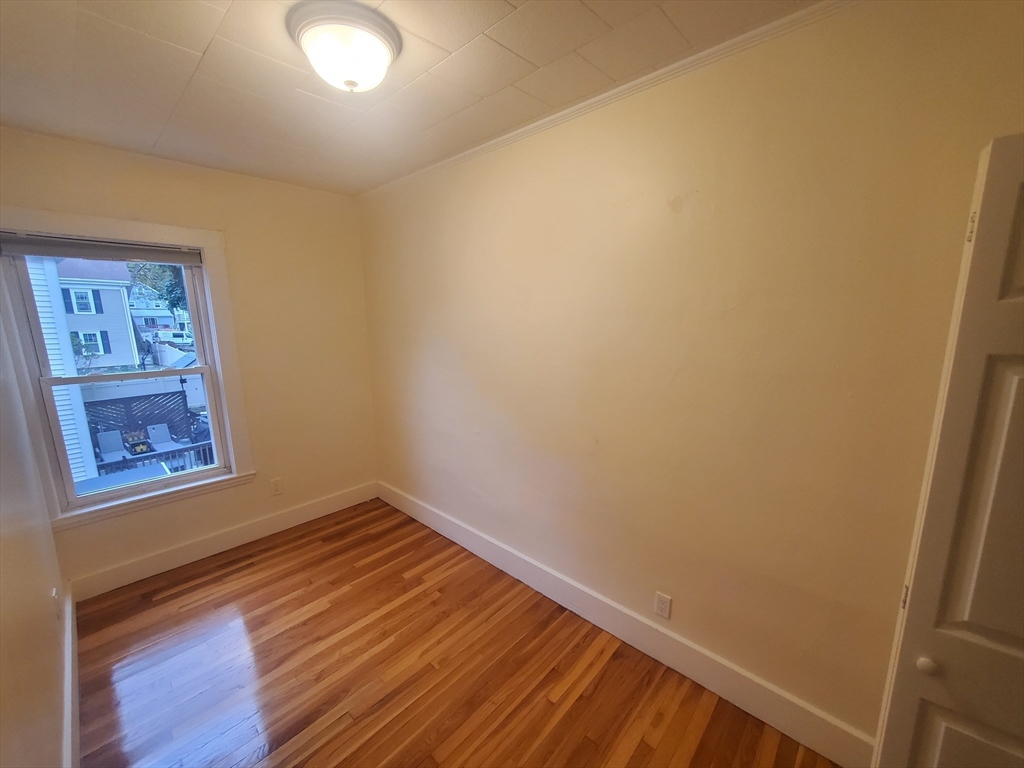 68 Nahant Avenue, Unit 2 Boston, MA 02122 - Photo 16 of 19 a view of an empty room with wooden floor