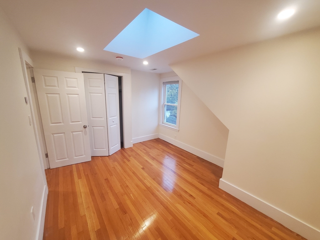 68 Nahant Avenue, Unit 2 Boston, MA 02122 - Photo 8 of 19 a view of empty room with wooden floor and fan