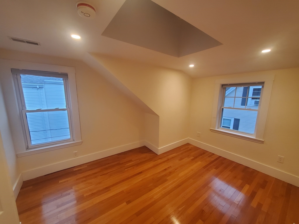 68 Nahant Avenue, Unit 2 Boston, MA 02122 - Photo 9 of 19 a view of an empty room with wooden floor and a window