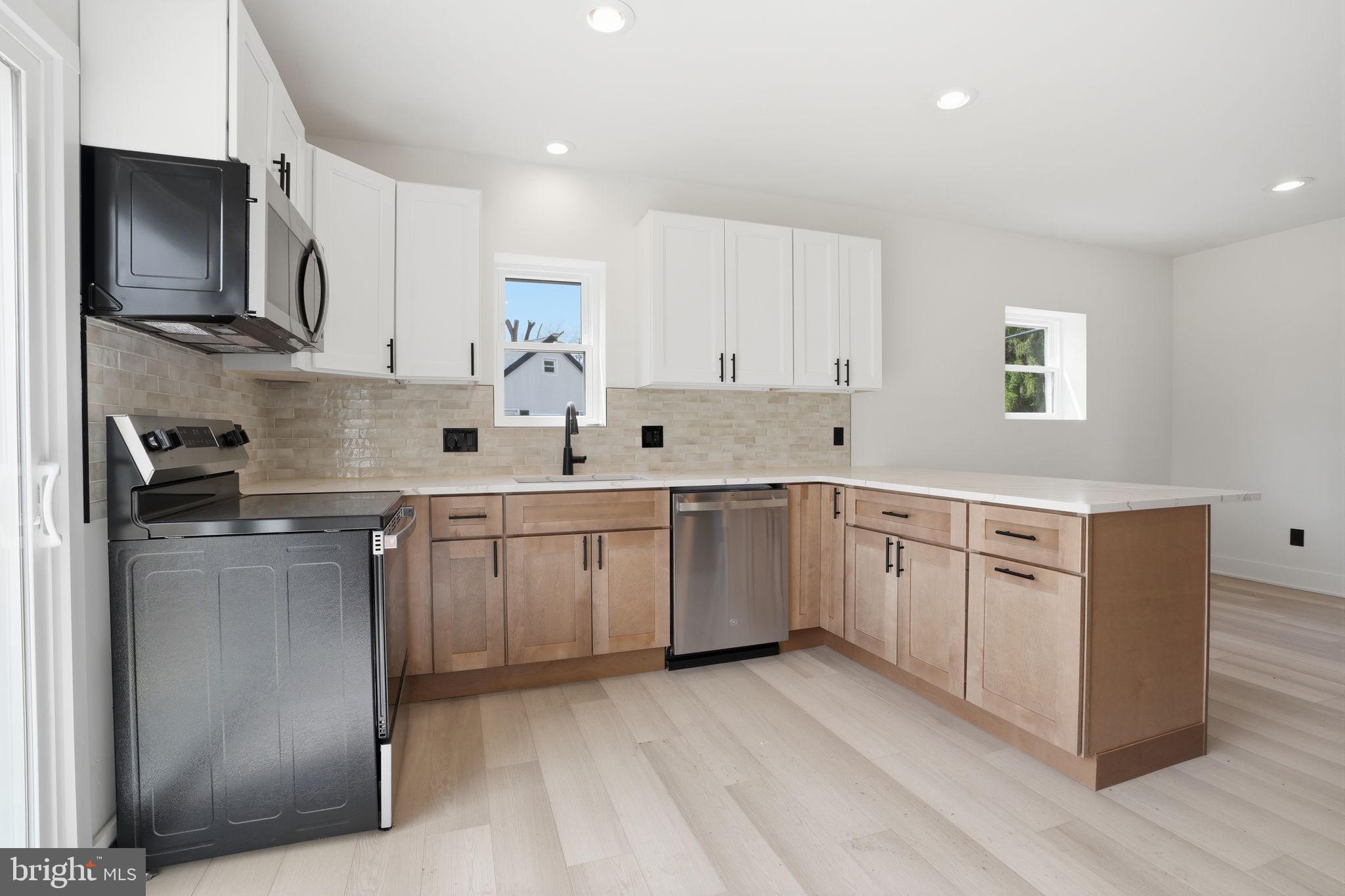 511 Sternermill Road Feasterville-Trevose, PA 19053 - Photo 11 of 32 a kitchen with white cabinets sink and stainless steel appliances