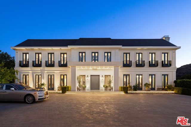 a view of building with cars parked in front of it