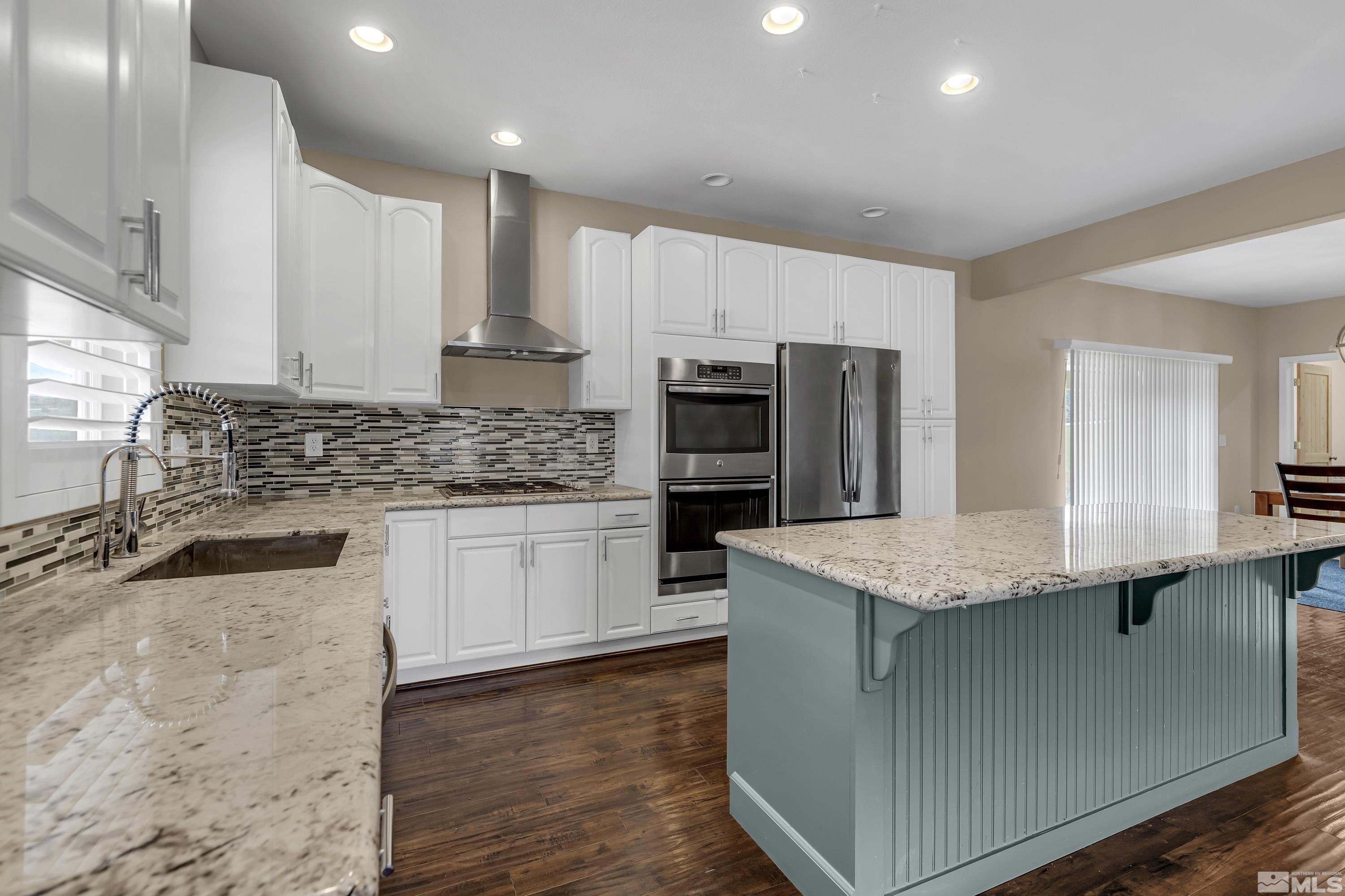 2055 Antelope Valley Road Reno, NV 89506 - Photo 2 of 40 a kitchen with stainless steel appliances granite countertop a sink stove and refrigerator