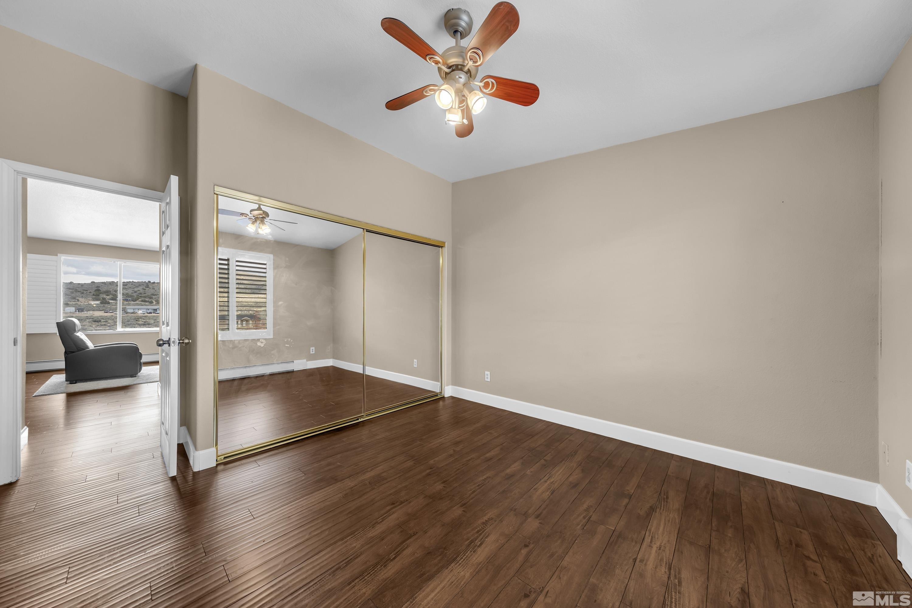 2055 Antelope Valley Road Reno, NV 89506 - Photo 22 of 40 an empty room with wooden floor and windows