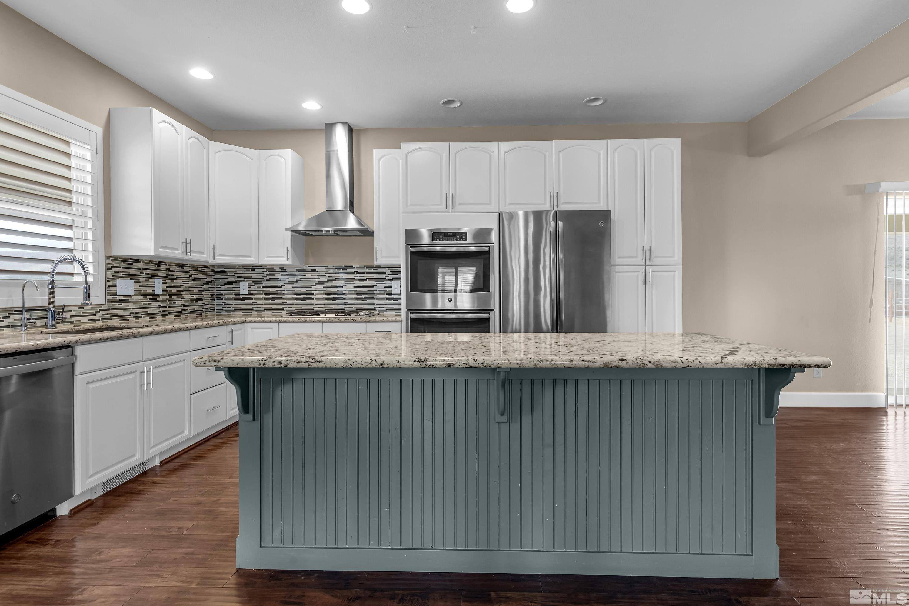 2055 Antelope Valley Road Reno, NV 89506 - Photo 3 of 40 a kitchen with kitchen island granite countertop wooden cabinets a sink and stainless steel appliances
