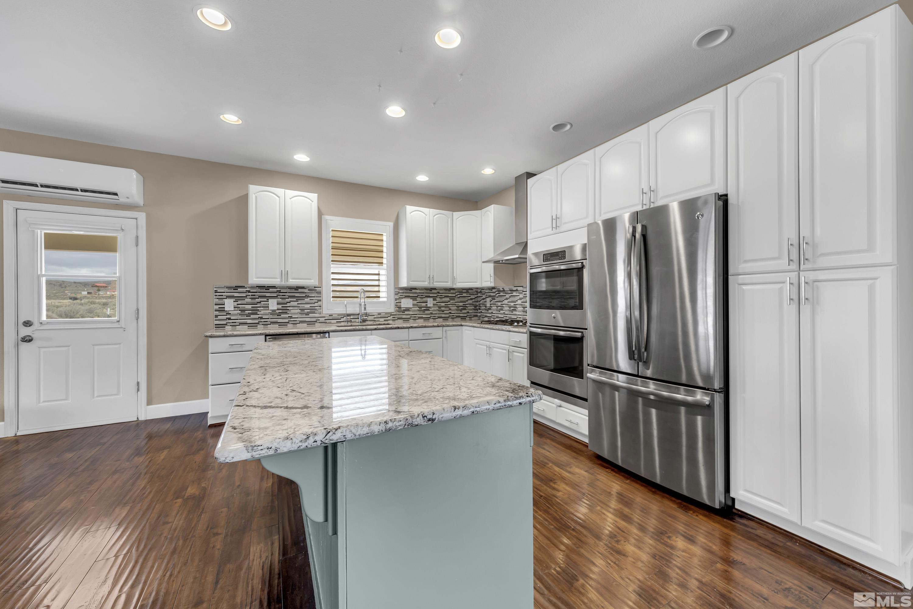 2055 Antelope Valley Road Reno, NV 89506 - Photo 4 of 40 a kitchen with stainless steel appliances granite countertop a refrigerator and a stove