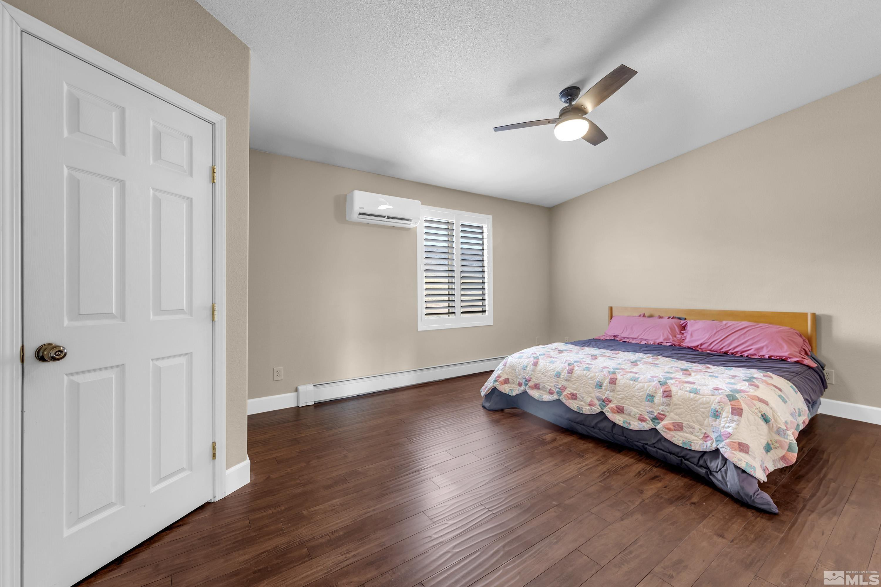 2055 Antelope Valley Road Reno, NV 89506 - Photo 10 of 40 a bedroom with a bed and wooden floor