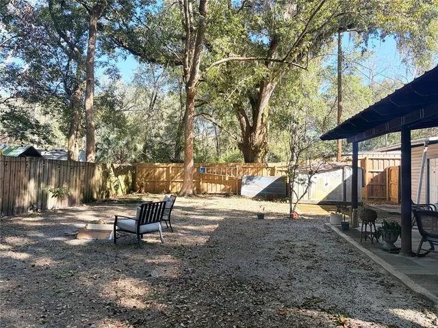 a view of a lake with a bench and trees around