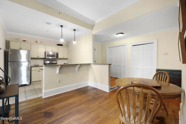 a white refrigerator freezer and a stove sitting inside of a kitchen