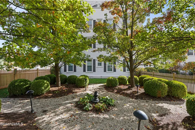 a living room with furniture a window and a flat screen tv