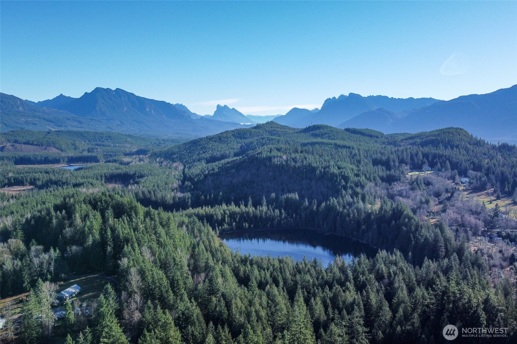10232 333rd Avenue Southeast Sultan, WA 98294 - Photo 30 of 40 a view of a lush green forest with mountains in the background