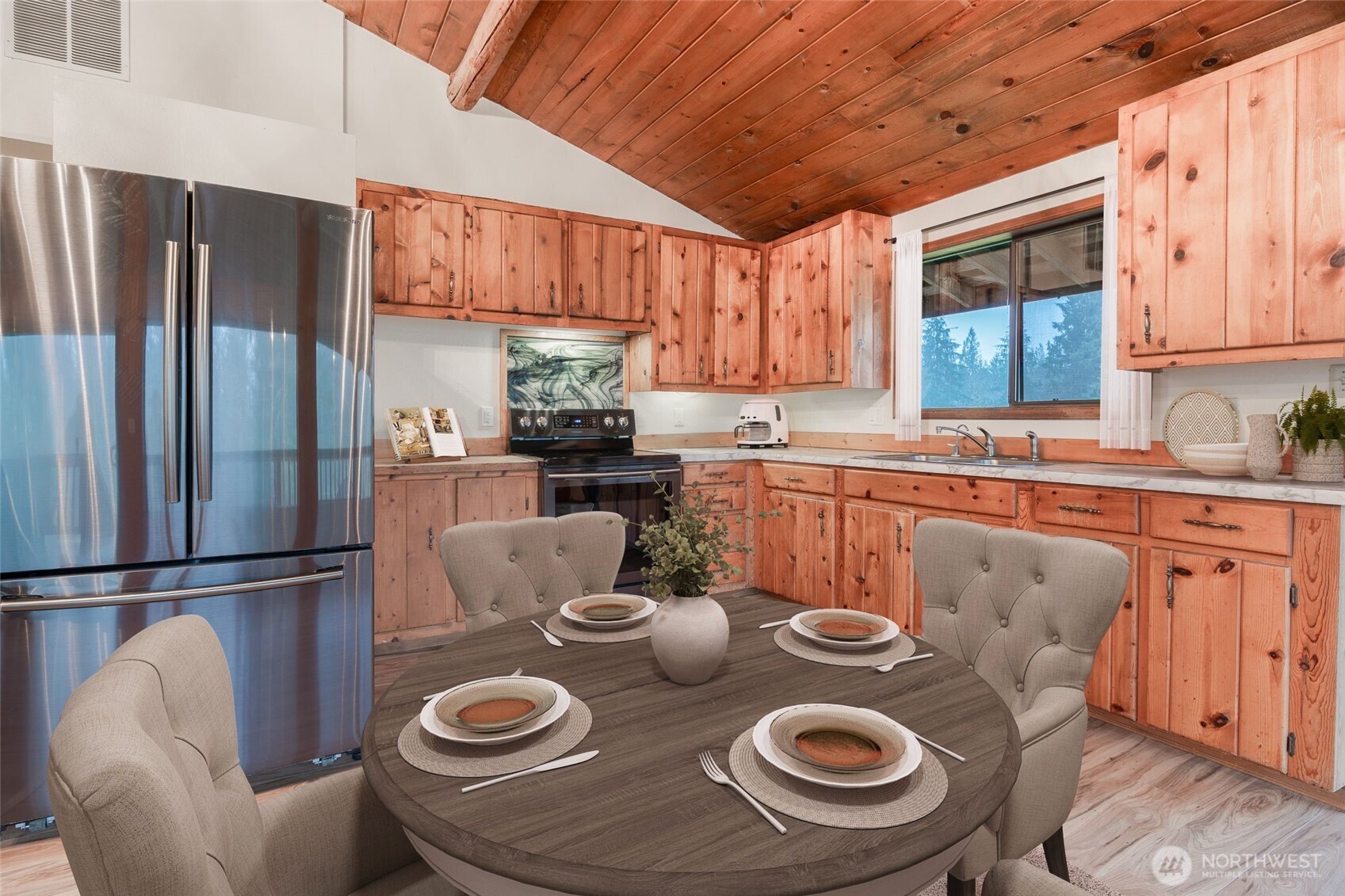 10232 333rd Avenue Southeast Sultan, WA 98294 - Photo 9 of 40 a kitchen with stainless steel appliances granite countertop a refrigerator a sink a stove and white cabinets with wooden floor