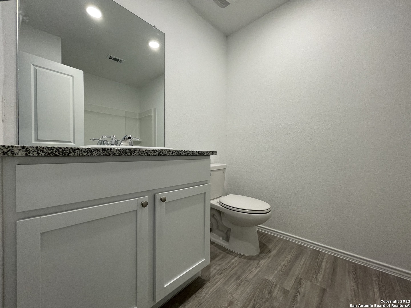 4324 Levee Ridge San Antonio, TX 78223 - Photo 12 of 24 a bathroom with a granite countertop toilet and a sink