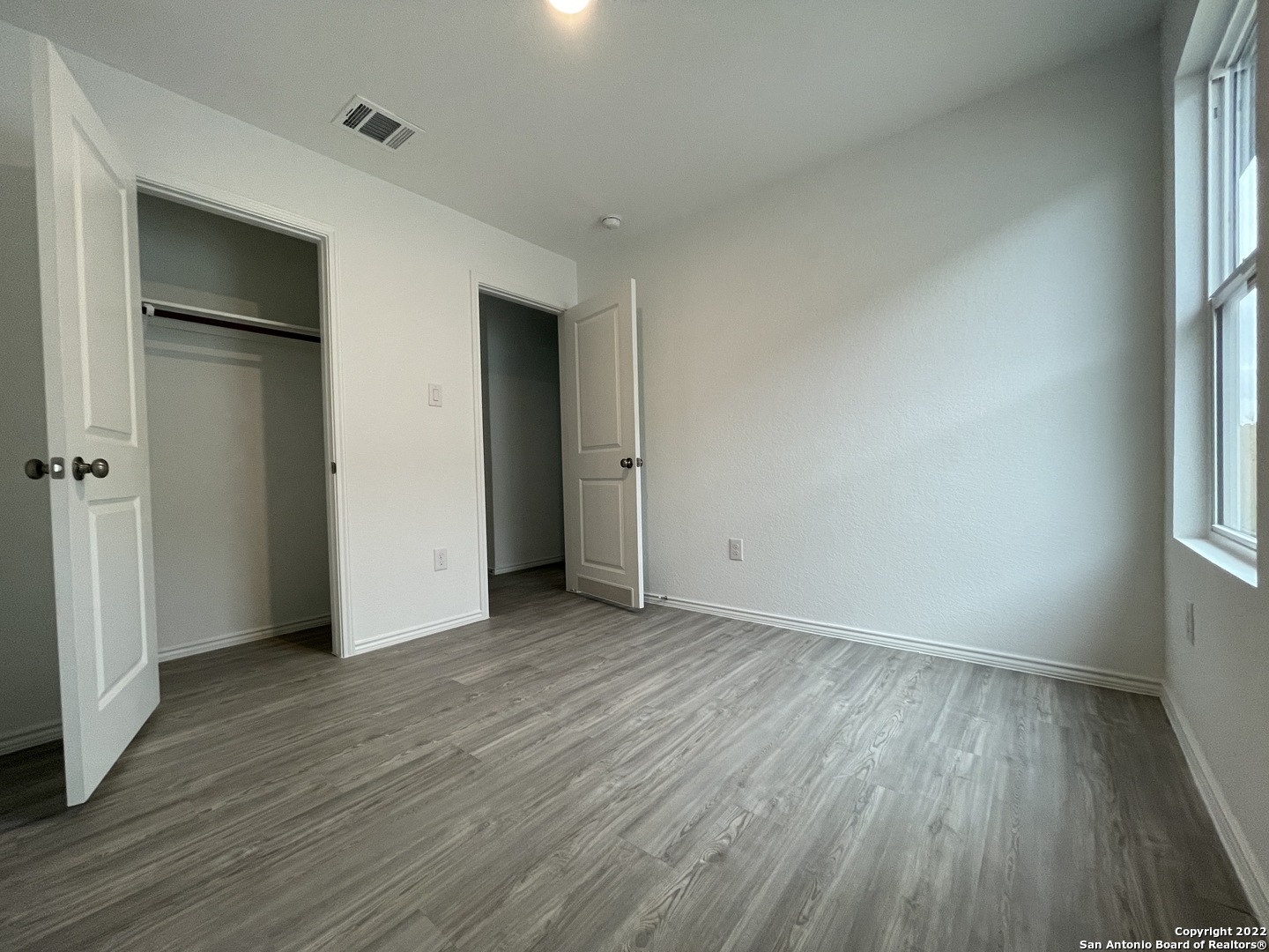 4324 Levee Ridge San Antonio, TX 78223 - Photo 14 of 24 an empty room with wooden floor and windows