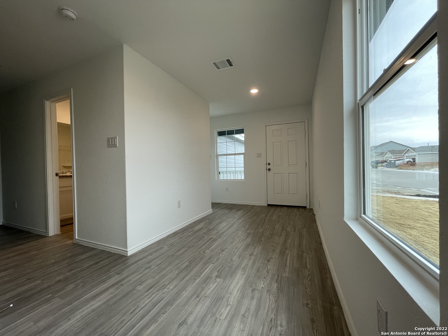 4324 Levee Ridge San Antonio, TX 78223 - Photo 2 of 24 an empty room with wooden floor and windows