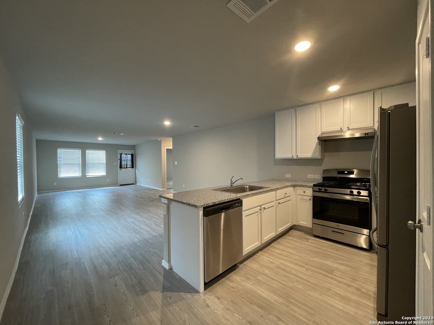 4324 Levee Ridge San Antonio, TX 78223 - Photo 3 of 24 a kitchen with stainless steel appliances granite countertop a stove a sink and a refrigerator
