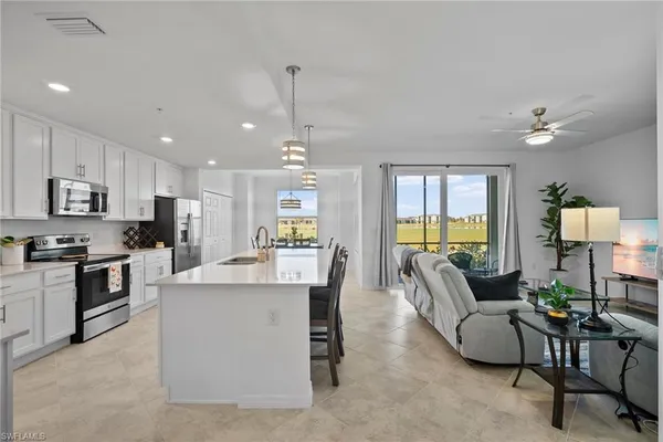 a living room with kitchen island furniture and a kitchen view