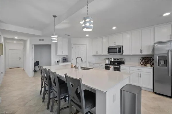 a dining room with furniture a chandelier and wooden floor