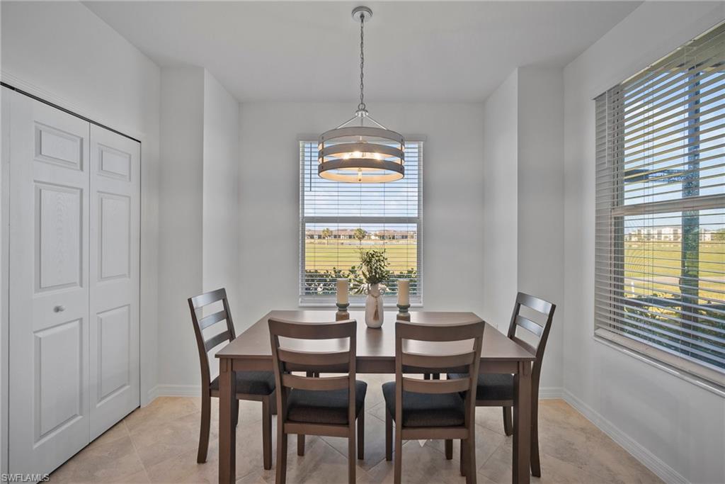 15980 Grassland Lane, Unit 2914 Babcock Ranch, FL 33982 - Photo 13 of 29 a dining room with furniture a chandelier and wooden floor