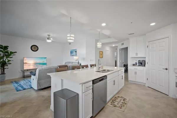 a large white kitchen with a large island