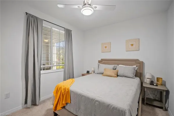a bed room with a bed and a flat tv screen on a dresser