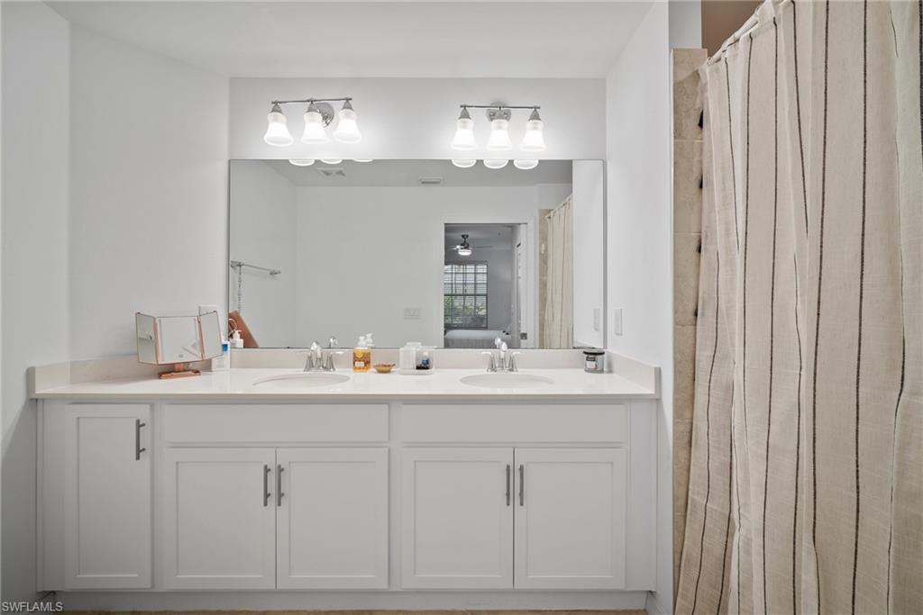 15980 Grassland Lane, Unit 2914 Babcock Ranch, FL 33982 - Photo 24 of 29 a bathroom with double sink and a mirror