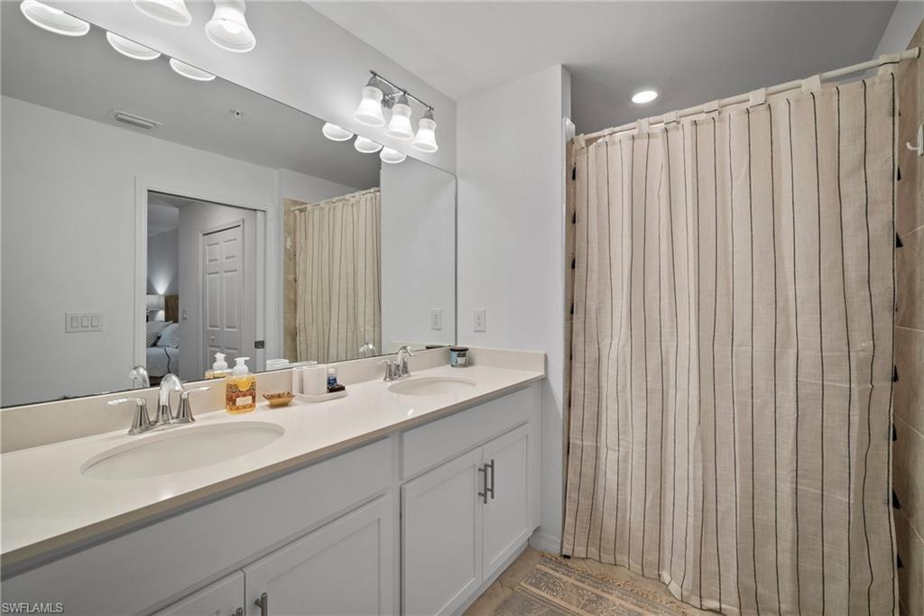 15980 Grassland Lane, Unit 2914 Babcock Ranch, FL 33982 - Photo 26 of 29 a en suite bathroom with a double vanity sink and a mirror