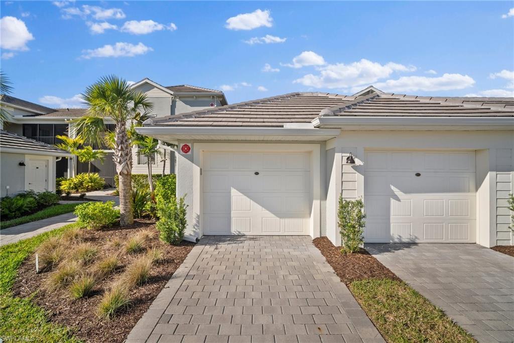 15980 Grassland Lane, Unit 2914 Babcock Ranch, FL 33982 - Photo 4 of 29 a view of a house with a yard and plants