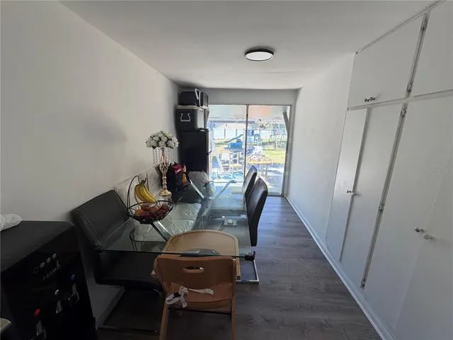 a dining room with furniture and wooden floor