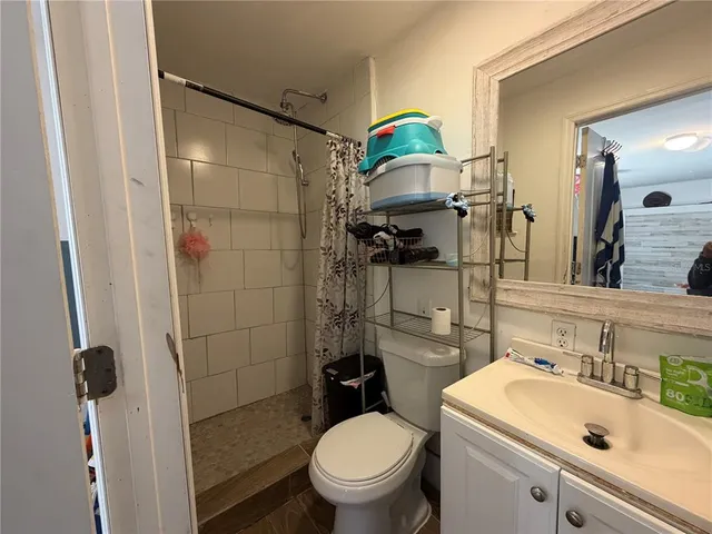 a bathroom with a sink toilet and shower