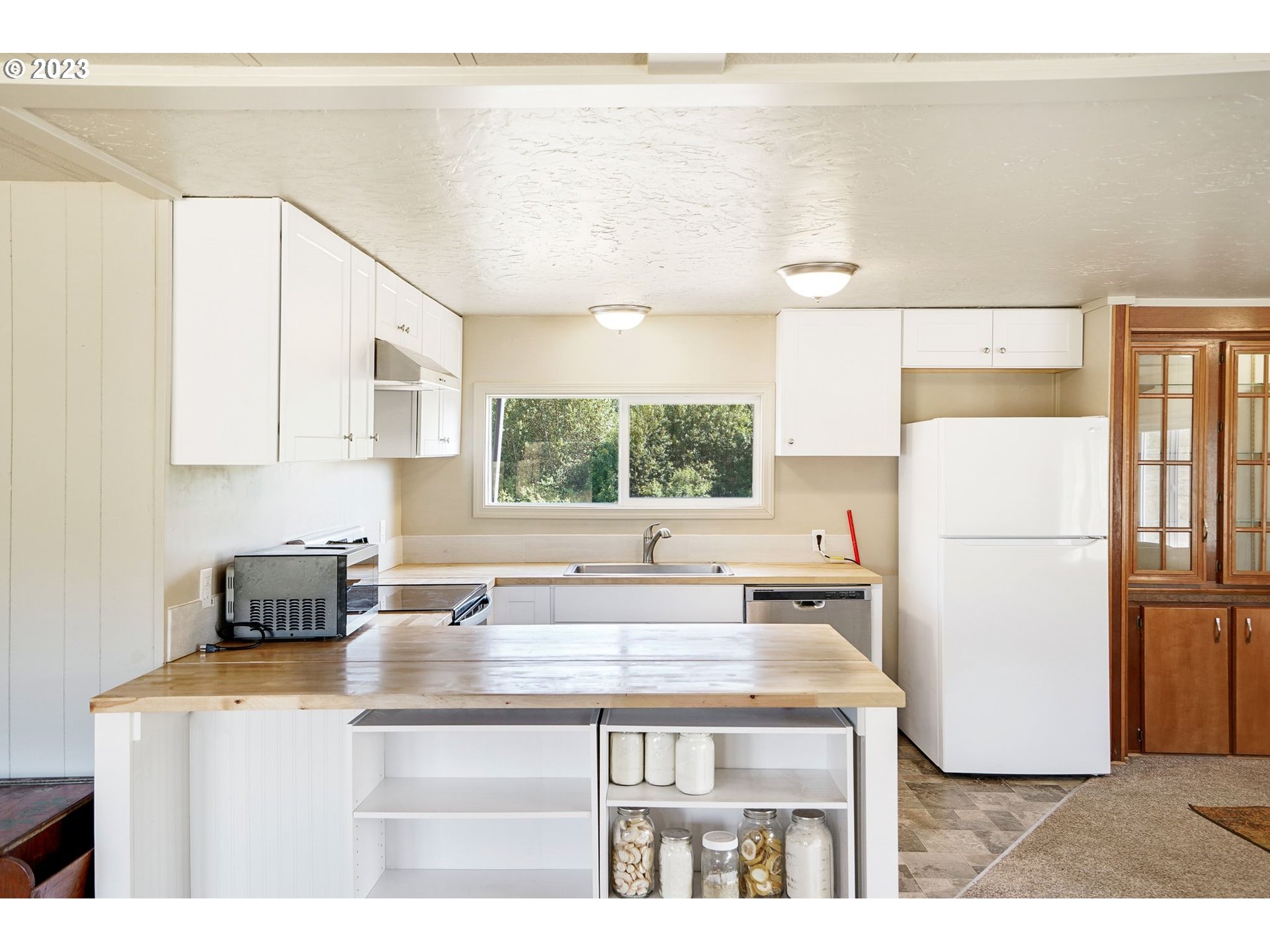 34075 Mt Pleasant Road Lebanon, OR 97355 - Photo 11 of 39 a kitchen with a refrigerator a sink and a cabinets