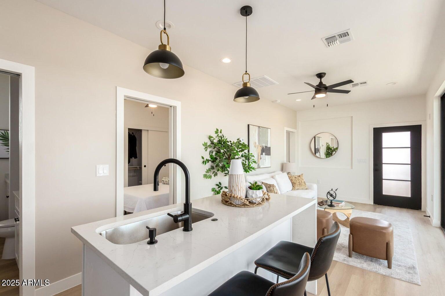 1508 West Sherman Street, Unit B Phoenix, AZ 85007 - Photo 7 of 16 a kitchen with a sink a counter and living room view
