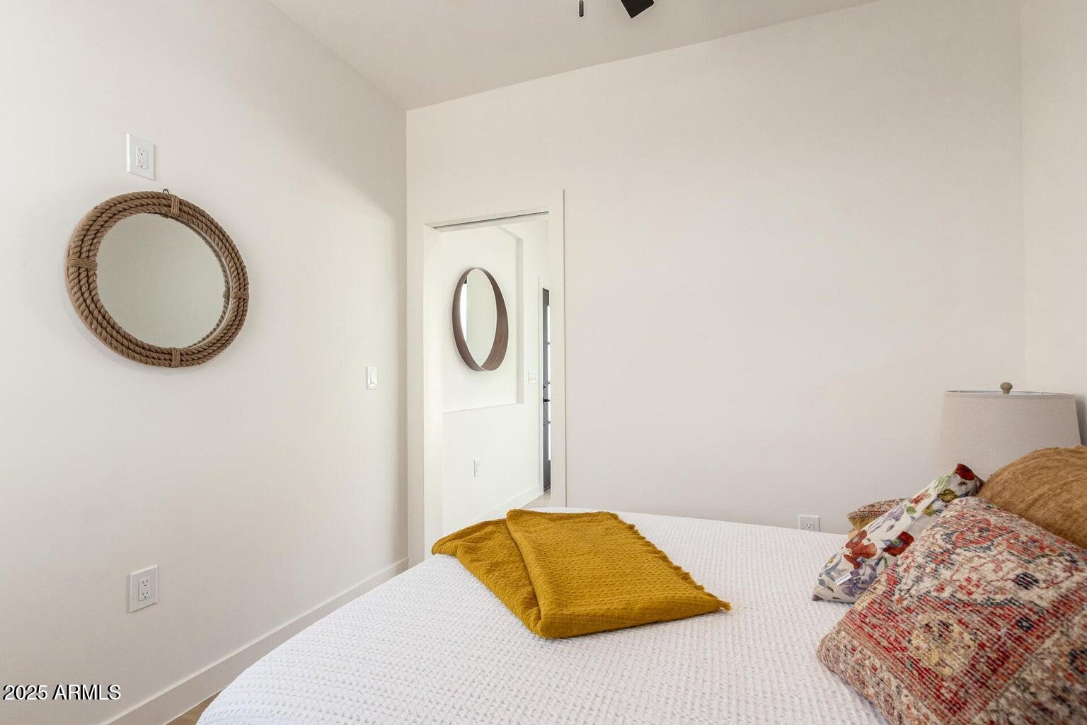 1508 West Sherman Street, Unit B Phoenix, AZ 85007 - Photo 10 of 16 a bedroom with a bed and a lamp on the dresser