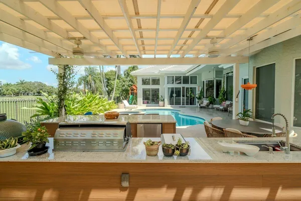 a view of a patio with couches table and chairs and potted plants