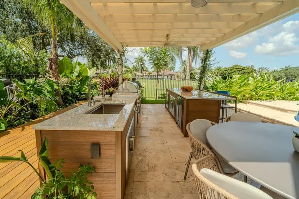 a view of a patio with table and chairs and potted plants