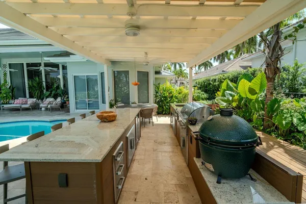 a dining room with furniture and a potted plant