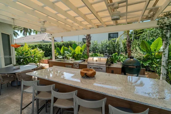 a dining room with furniture and potted plants