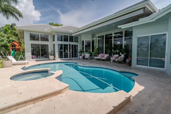 a view of a house with sitting area and garden