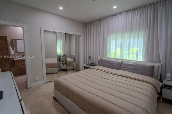 a bedroom with a bed and a mirror