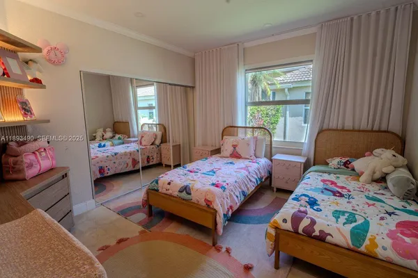 a bedroom with two beds and a window